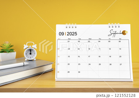 September desk calendar for 2025 year on work table with yellow. 121552128