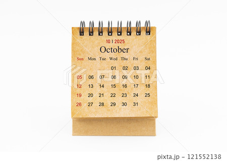 Brown mini desk calendar for October 2025 isolated on white. Brown mini desk calendar for October 2025 isolated on white. 121552138