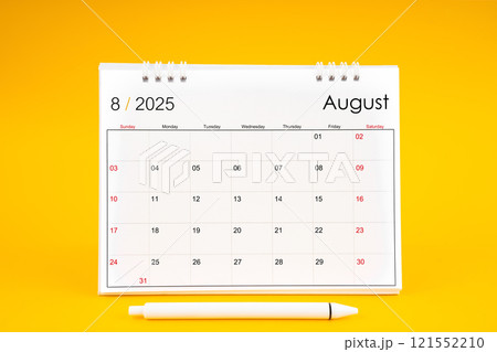 August 2025, Monthly desk calendar for 2025 year and pen on yellow background. 121552210