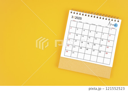 March 2025 desk calendar on yellow color background. 121552523