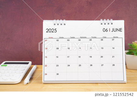 June 2025 white calendar and calculator with pen. June 2025 white calendar and calculator with pen. 121552542