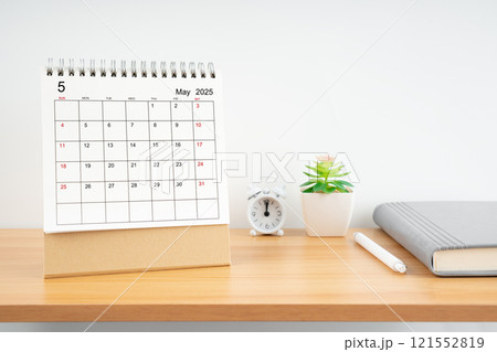 May 2025, Monthly desk calendar for 2025 year on wooden table. 121552819
