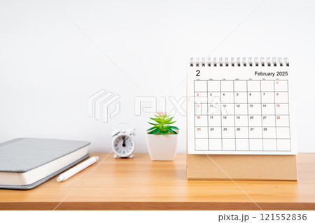 February 2025, Monthly desk calendar for 2025 year on wooden table. 121552836