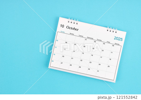 October 2025, Monthly desk calendar for 2025 year on blue background. 121552842