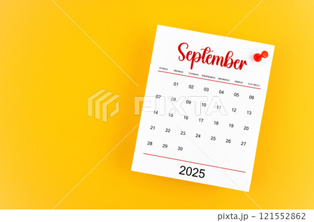 September 2025 calendar page with red push pin on yellow background. 121552862