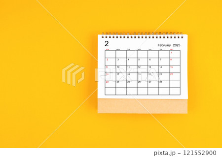 February 2025 desk calendar on yellow color background, position with copy space. 121552900