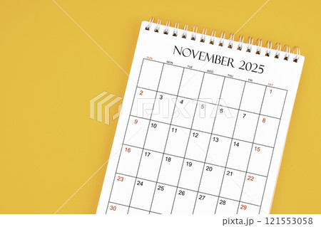 November 2025 desk calendar on yellow color background, position with copy space. 121553058