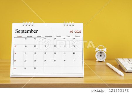 September 2025, Monthly desk calendar for 2025 year on wooden table. 121553178