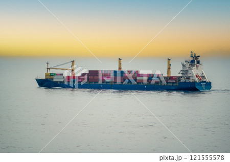 Dubai, UAE - 14 November 2024: Cargo ship loaded with various containers cruising in open sea. Ocean freight transport vessel moving goods globally. Maritime industry and international shipping 121555578