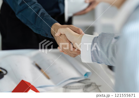 Engineer and architect collaborate on office blueprint business meeting modern workspace professional environment partnership concept 121555671