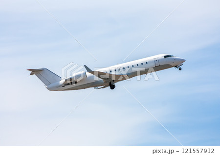 Take-off a white regional jet against a blue sky Take-off a white regional jet against a blue sky 121557912