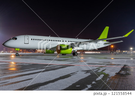 Modern passenger airplane on the night airport apron Modern passenger airplane on the night airport apron 121558544