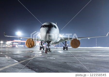 Modern passenger jet plane on the night airport apron Modern passenger jet plane on the night airport apron 121558545