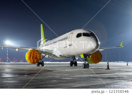 Modern passenger aircraft on the night airport apron Modern passenger aircraft on the night airport apron 121558546