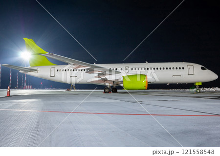 Modern passenger airliner on the night airport apron Modern passenger airliner on the night airport apron 121558548