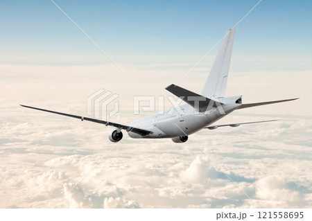 White wide body passenger aircraft flies in the air above the clouds 121558695