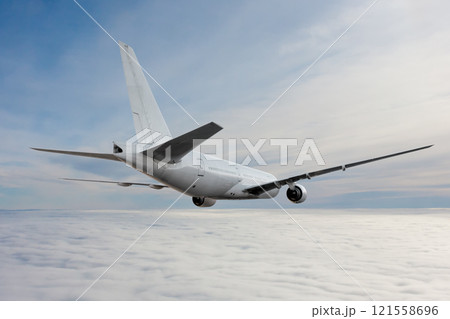 White wide body passenger airplane flying in the air above the clouds 121558696