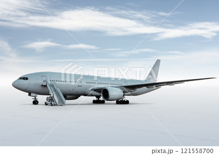 Wide body passenger airplane with a boarding steps isolated on bright background with sky Wide body passenger airplane with a boarding steps isolated on bright background with sky 121558700