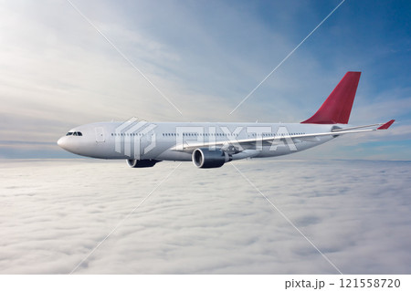 Wide body passenger airplane flying in the air above the clouds 121558720