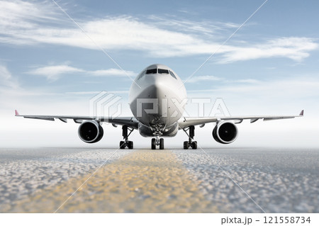 Front view of wide body passenger aircraft isolated on bright background with sky Front view of wide body passenger aircraft isolated on bright background with sky 121558734