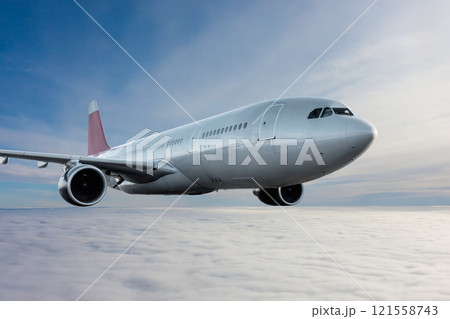 Wide body passenger jet plane flies in the air above the clouds Wide body passenger jet plane flies in the air above the clouds 121558743