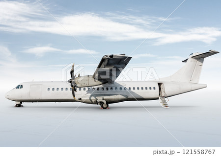 White passenger turboprop aircraft with an open staircase ladder isolated on bright background with sky 121558767