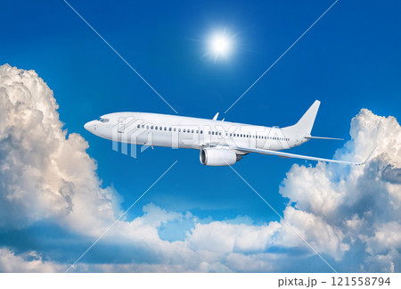 White passenger airliner fly in the air above scenic clouds White passenger airliner fly in the air above scenic clouds 121558794