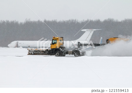 Airfield snow blower cleaning the runway at the airport in a severe blizzard 121559413