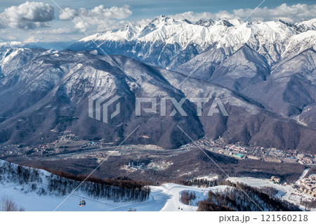 High mountain peaks covered with snow on a clear sunny day 121560218