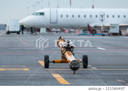 Towbar for pushback airplanes at the airport apron Towbar for pushback airplanes at the airport apron 121560497