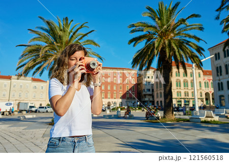 Young Woman Taking Photos in Coastal Town Young Woman Taking Photos in Coastal Town 121560518
