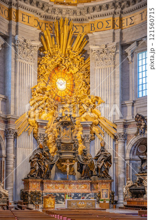 In the apse of St. Peter's Basilica, the magnificent St. Peter Cathedra is elevated by four significant Doctors of the Church, showcasing intricate artistry and deep religious symbolism. 121560715