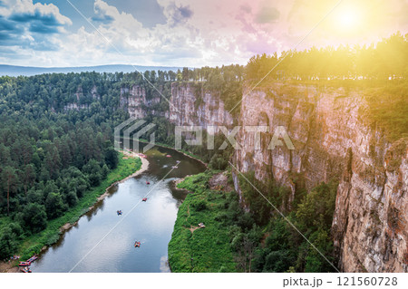 The rocky shore of a picturesque river. Rafting on catamarans on the flood The rocky shore of a picturesque river. Rafting on catamarans on the flood 121560728