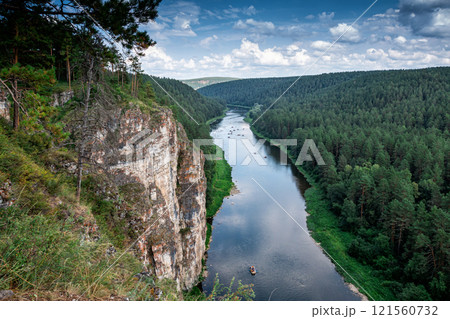 The rocky shore of a picturesque river. Rafting on catamarans on the flood 121560732