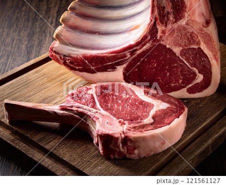Raw t-bone beef on the wooden plate 121561127