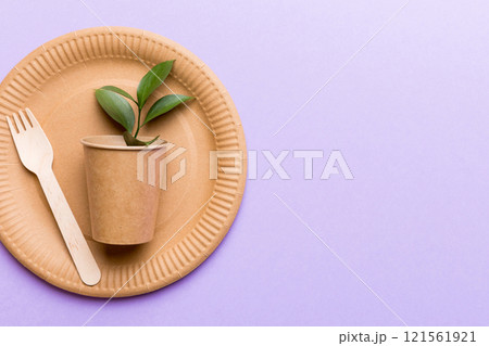 set of empty reusable disposable eco-friendly plates, cups, utensils on light white colored table background. top view. Biodegradable craft dishes. Recycling concept. Close-up set of empty reusable disposable eco-friendly plates, cups, utensils on light white colored table background. top view. Biodegradable craft dishes. Recycling concept. Close-up 121561921