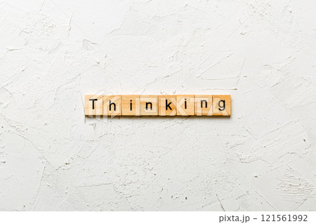 thinking word written on wood block. thinking text on cement table for your desing, concept thinking word written on wood block. thinking text on cement table for your desing, concept 121561992