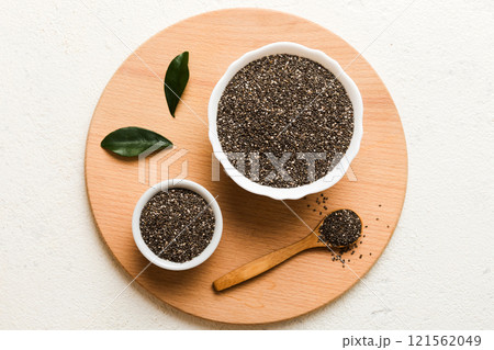Chia seeds in bowl and spoon on colored background. Healthy Salvia hispanica in small bowl. Healthy superfood 121562049