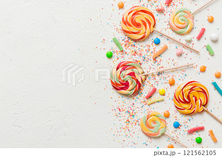 Tasty appetizing Party Accessories Happy Birthday Sweet. Different types of candies on colored background, copy space. Colorful birthday party background Tasty appetizing Party Accessories Happy Birthday Sweet. Different types of candies on colored background, copy space. Colorful birthday party background 121562105