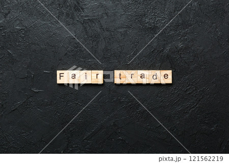 fair trade word written on wood block. fair trade text on cement table for your desing, concept fair trade word written on wood block. fair trade text on cement table for your desing, concept 121562219