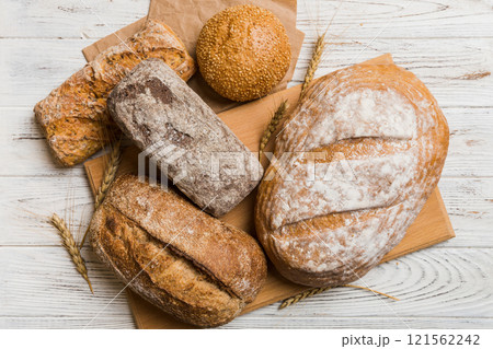 Assortment of freshly baked bread with napkin on rustic table top view. Healthy unleavened bread. French bread 121562242