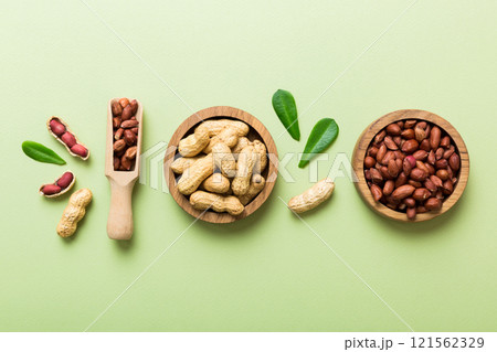 Fresh healthy peanuts in bowl on colored table background. Top view Healthy eating bertholletia concept. Super foods Fresh healthy peanuts in bowl on colored table background. Top view Healthy eating bertholletia concept. Super foods 121562329