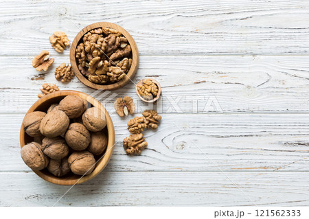 Fresh healthy walnuts in bowl on colored table background. Top view Healthy eating bertholletia concept. Super foods Fresh healthy walnuts in bowl on colored table background. Top view Healthy eating bertholletia concept. Super foods 121562333