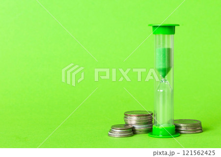 Deadline and time is money concept with hourglass and US coins currency. sand clock time for saving concept 121562425