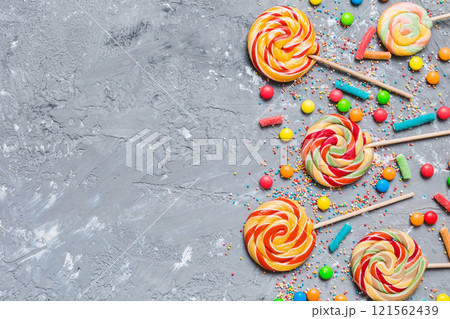 Tasty appetizing Party Accessories Happy Birthday Sweet. Different types of candies on colored background, copy space. Colorful birthday party background Tasty appetizing Party Accessories Happy Birthday Sweet. Different types of candies on colored background, copy space. Colorful birthday party background 121562439
