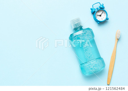 Mouthwash and other oral hygiene products on colored table top view with copy space. Flat lay. Dental hygiene. Oral care products and space for text on light background. concept 121562484