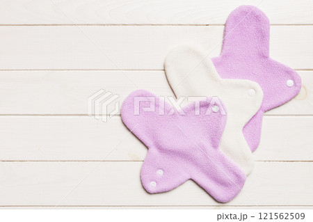 Eco-friendly reusable fabric women's pads. set of colorful bright reusable menstrual pads. zero waste woman periods concept top view with copy space Eco-friendly reusable fabric women's pads. set of colorful bright reusable menstrual pads. zero waste woman periods concept top view with copy space 121562509