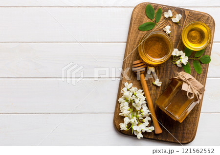 honey jar with acacia flowers and leaves. fresh honey top view flat lay honey jar with acacia flowers and leaves. fresh honey top view flat lay 121562552