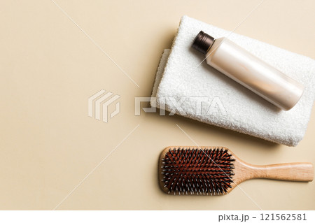 cosmetic for hair care, cream and towel on a colored background top view. flat lay cosmetic for hair care, cream and towel on a colored background top view. flat lay 121562581