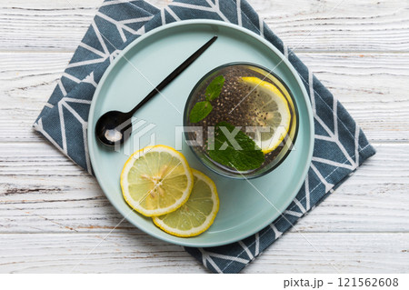 Healthy breakfast or morning with chia seeds lemon and mint on table background, vegetarian food, diet and health concept. Chia pudding with lemon and mint 121562608